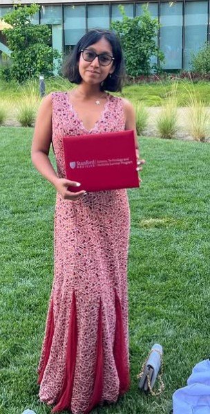 Researcher holding a Stanford Medicine program certificate
