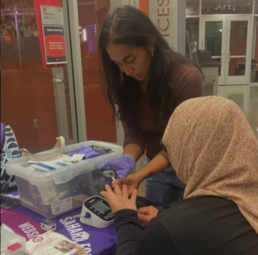 Volunteer supporting a community health screening