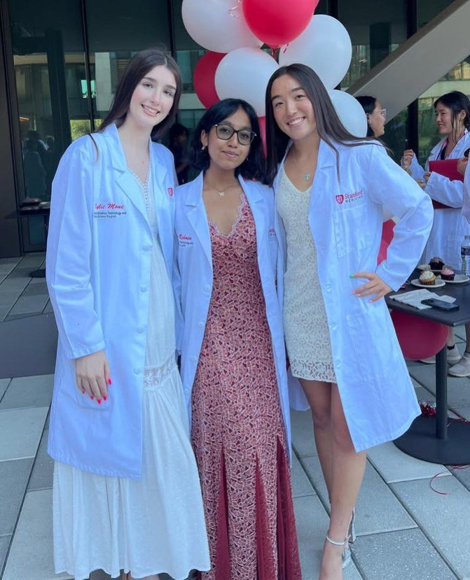 Three students wearing Stanford Medicine laboratory coats