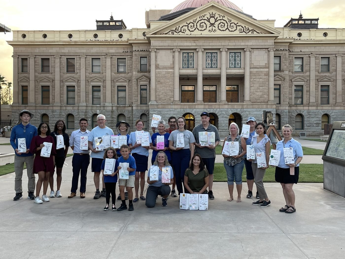 Volunteers holding Lights of Hope bags in front of the Arizona State Capitol