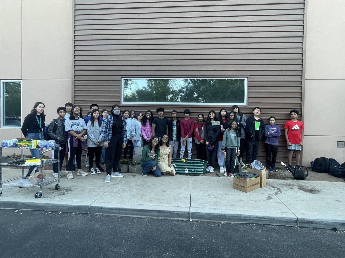 The Earth Day volunteer group beside the finished garden bed at BASIS Chandler