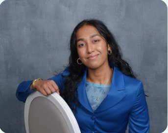 Press headshot of Ariana Rahman in a blue suit
